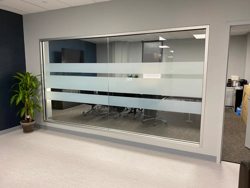 Office conference room with frosted privacy stripes on the glass partition wall